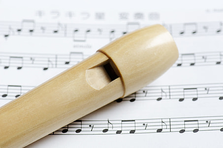 white wooden flute on white printer paper thumbnail