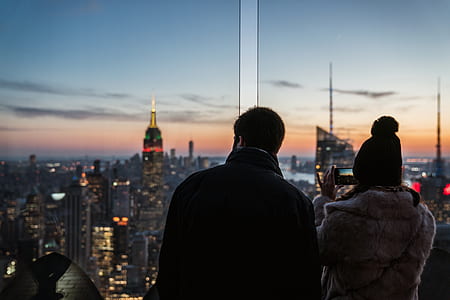 man and woman standing near window during daytime thumbnail
