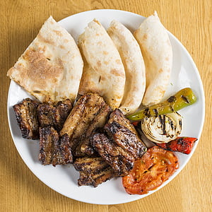 grilled meat beside grilled tomato on top white plate thumbnail