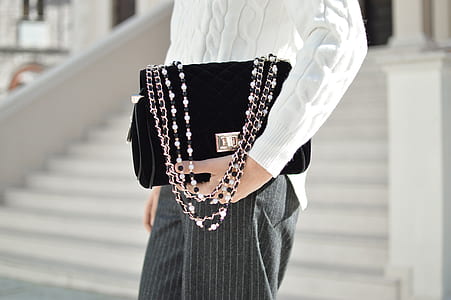 person holding black handbag thumbnail