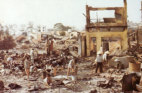 Civilians sort through the ruins of their homes in Cholon in the Vietnam War thumbnail