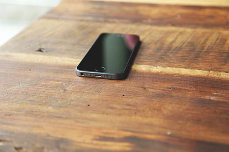 space gray iPhone 5s on brown surface thumbnail