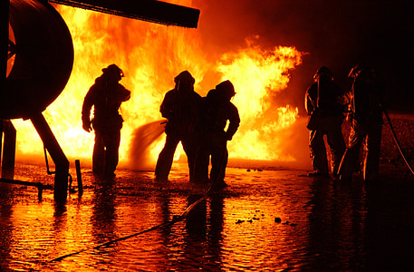 five men standing beside fire thumbnail