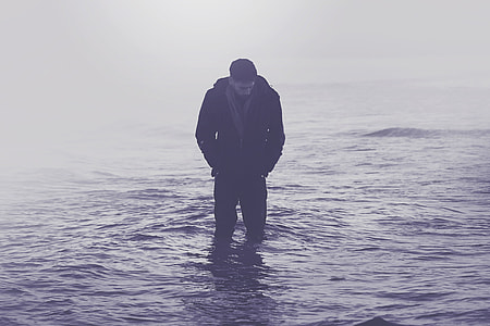 A man standing in the ocean water thumbnail