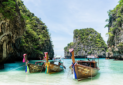 three brown motor boats near shorelines thumbnail