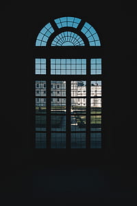 silhouette of window in front of white concrete building thumbnail
