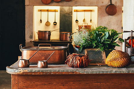 brown metal food container beside vegetables and fruits on table thumbnail