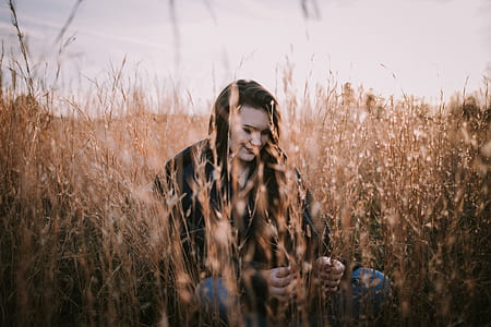 woman standing on brown leafed plants thumbnail