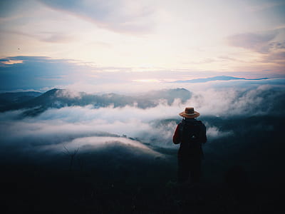 person wearing hat under clouds during daytime thumbnail