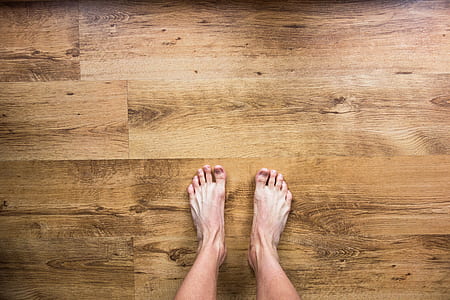 person standing on wooden floor thumbnail