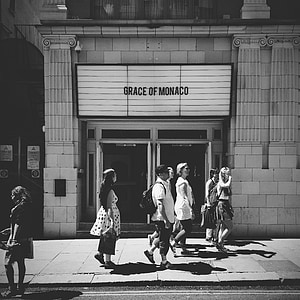 grayscale photo of people walking on sidewalk thumbnail