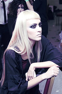 woman with eyeliner sitting on chair thumbnail