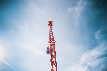 people riding red amusement ride thumbnail