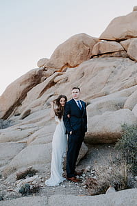 man and woman standing in front of rocks thumbnail