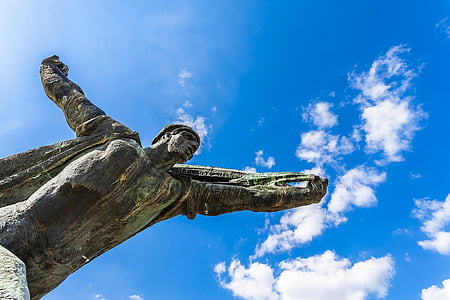 man statue under blue sky thumbnail