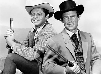 grayscale photo of two man holding rifle thumbnail