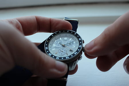 person adjusting chronograph watchn thumbnail