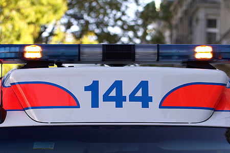 white and blue police car during daytime thumbnail