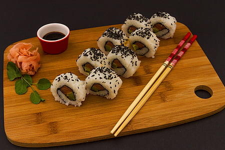 white sushi roll on brown wooden chopping board thumbnail