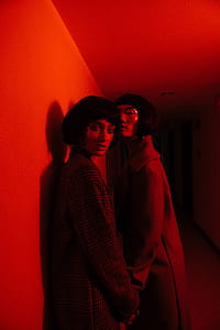 women wearing grey coats while holding hands thumbnail