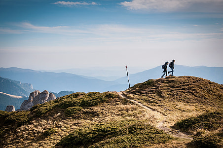two person on top of the Mountain seeing landmark under white cloud during daytime thumbnail