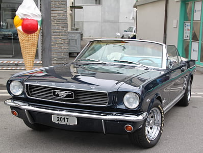 classic black Ford Mustang convertible coupe parked near ice cream standee thumbnail