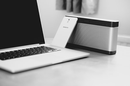 white Samsung Android smartphone beside MacBook Pro thumbnail