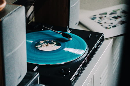 black turntable playing green vinyl record thumbnail