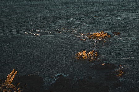 birds eye photo of rock formations and body of watr thumbnail