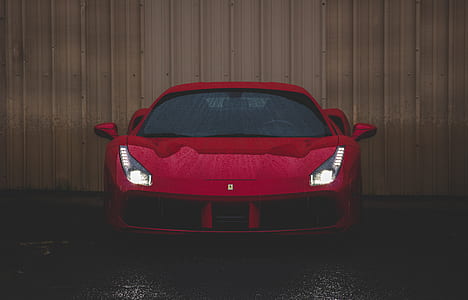 red car near wooden fence thumbnail