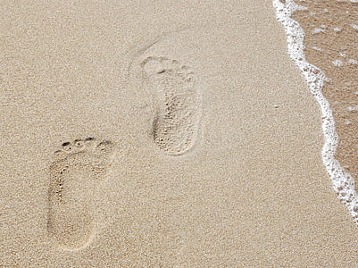 footprints on brown sand close-up photography at daytime thumbnail