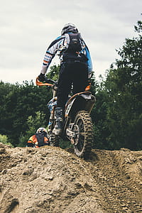 person riding on motocross dirt motorcycle during daytime thumbnail