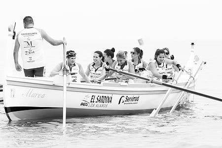 grayscale photography of people riding boat thumbnail