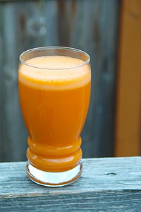 orange liquid inside clear drinking glass thumbnail