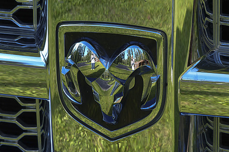 shinny chrome Dodge emblem in close-up photo thumbnail