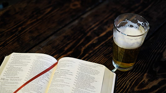 clear glass cup filled with beer near book thumbnail
