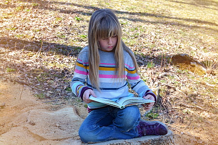 girl reading book outdoors thumbnail