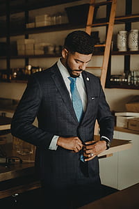 men standing near brown ladder and table wearing suit jacket thumbnail