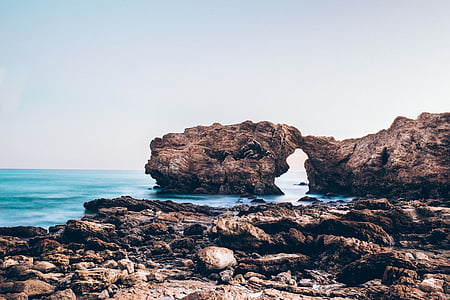 landscape photo of gray rock formation near body of water thumbnail