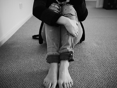 woman sitting on floor in grayscale photography thumbnail