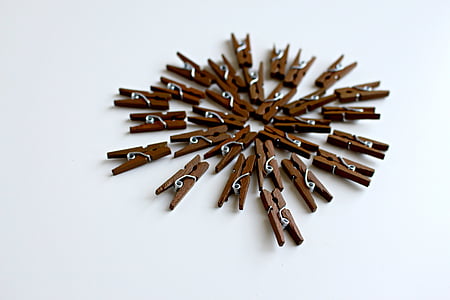 brown wooden laundry clips on white surface thumbnail