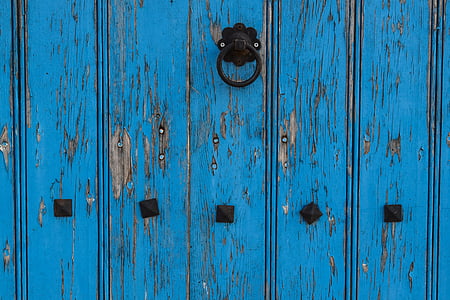 blue wooden door with black steel knocker thumbnail