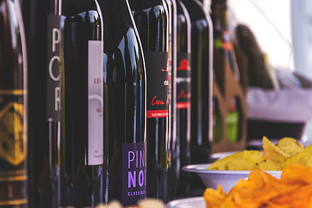 Closeup shot of red wine bottles on a table thumbnail