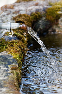 close-up photography of water flows from gray metal pipe thumbnail