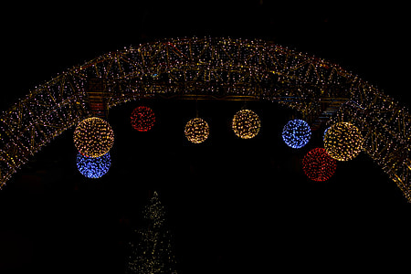 assorted-colored string ball lights hanged on arc of string lights thumbnail