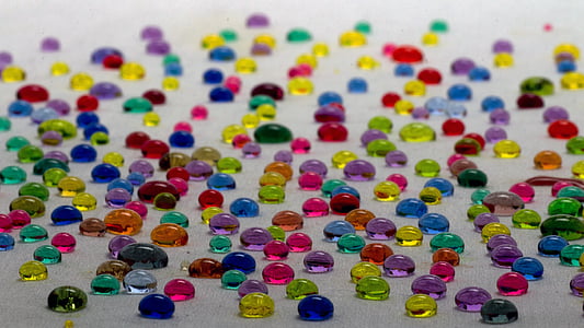 assorted-color stones on white surface thumbnail