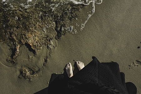 woman standing on brown sand thumbnail