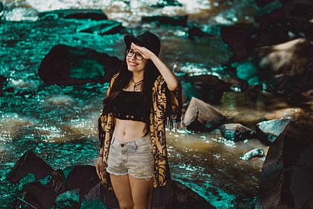 smiling woman standing near body of water thumbnail