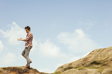 man standing on top of rock thumbnail