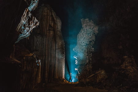 person inside cave with blue light thumbnail